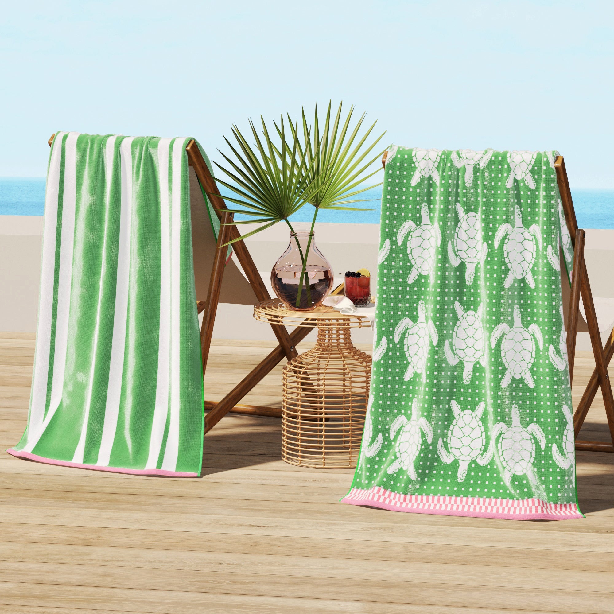 Maui Cotton Velour Beach Towel in vibrant green designs displayed on a chair by the beach.