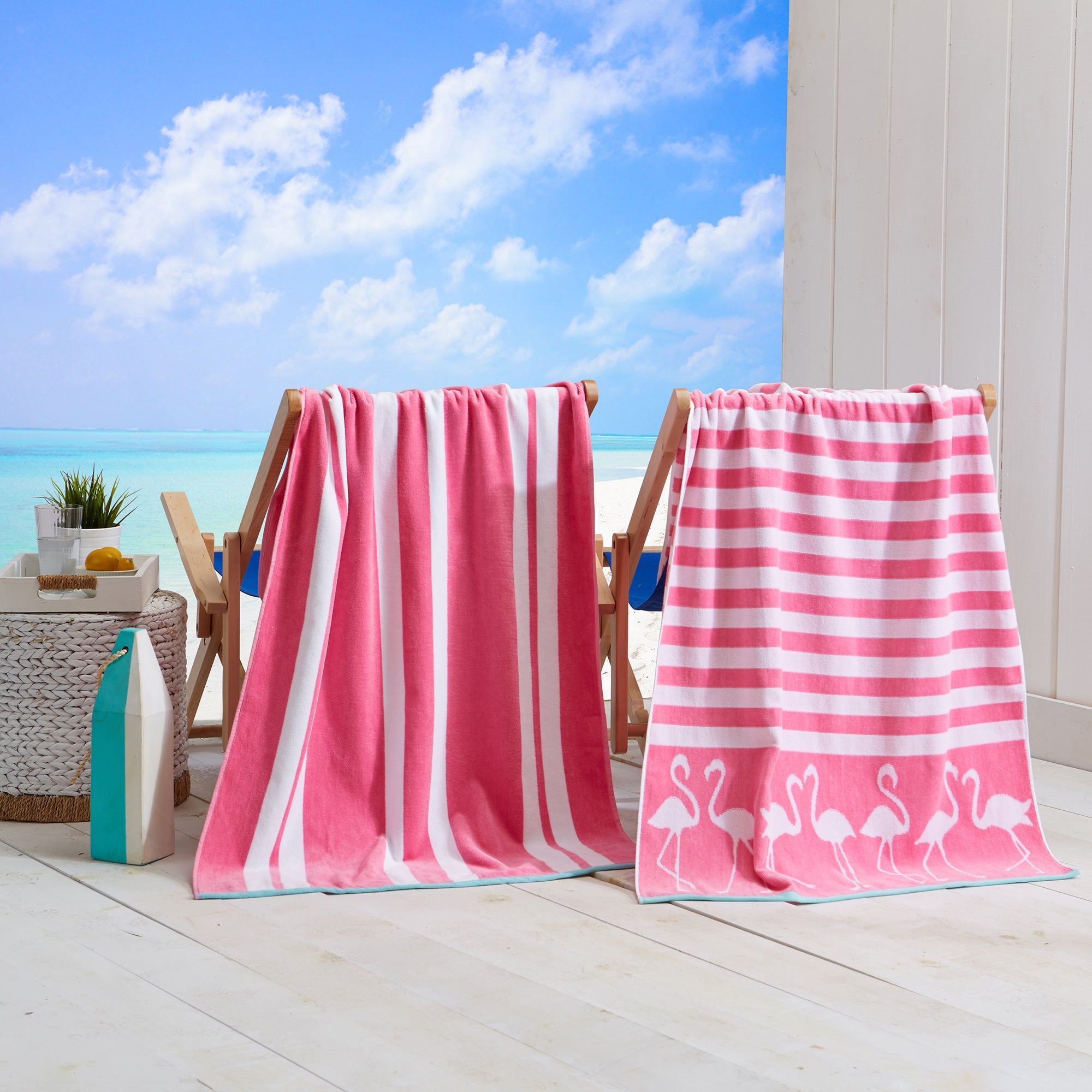 Maui Cotton Velour Beach Towel in vibrant green designs displayed on a chair by the beach.