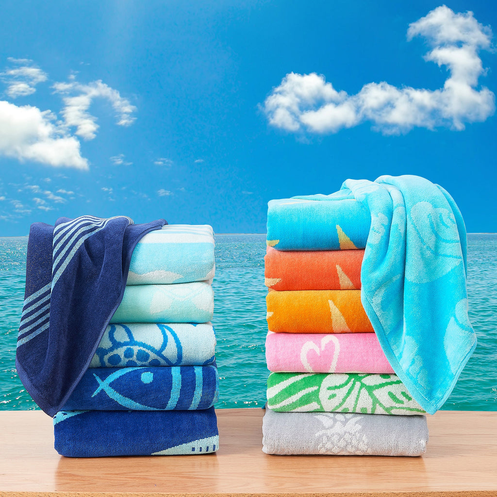 Maui Cotton Velour Beach Towel in vibrant green designs displayed on a chair by the beach.