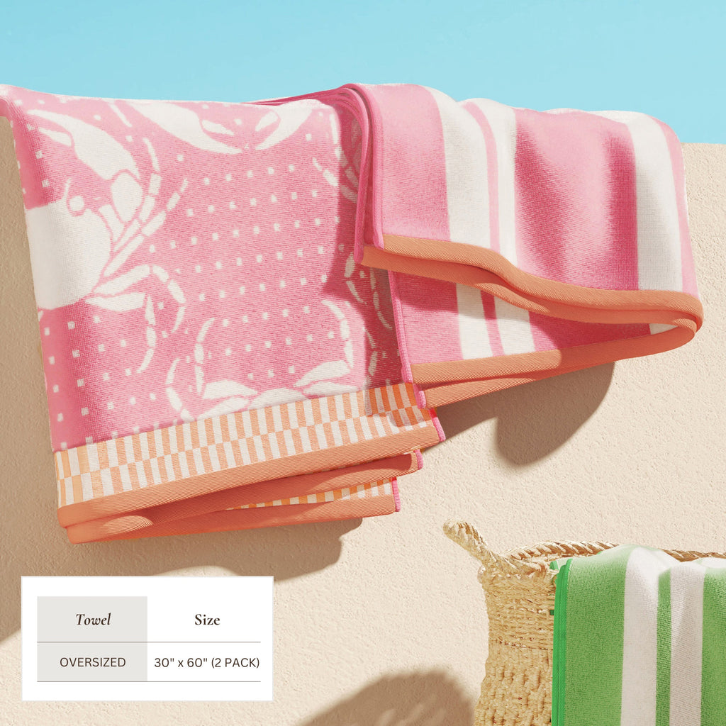 Maui Cotton Velour Beach Towel in vibrant green designs displayed on a chair by the beach.