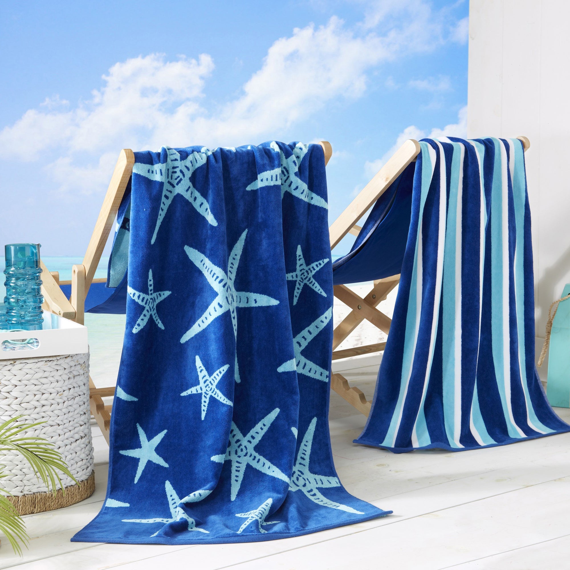 Maui Cotton Velour Beach Towel in vibrant green designs displayed on a chair by the beach.