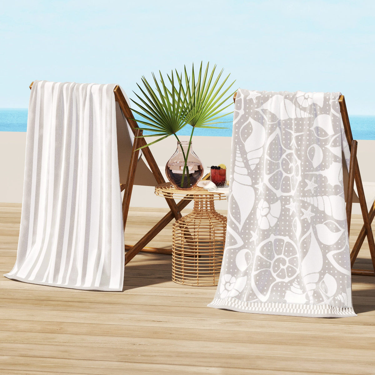 Maui Cotton Velour Beach Towel in vibrant green designs displayed on a chair by the beach.