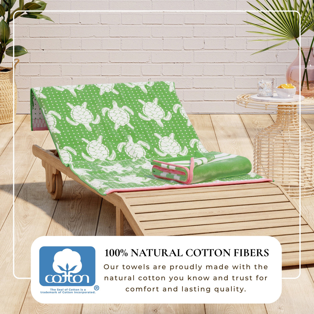 Maui Cotton Velour Beach Towel in vibrant green designs displayed on a chair by the beach.