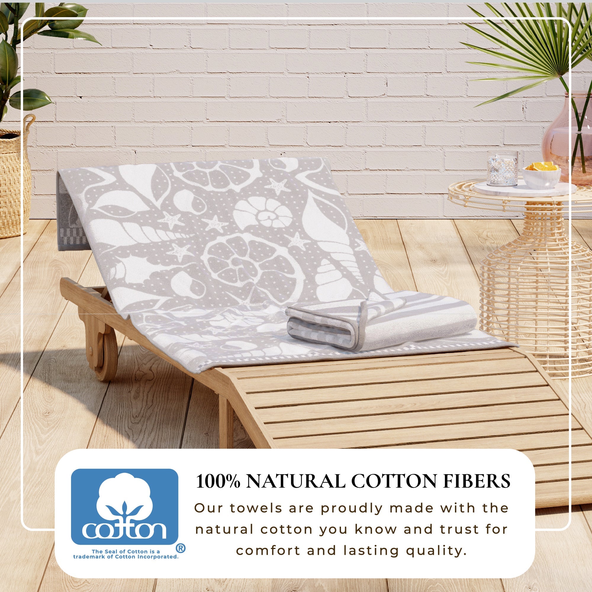 Maui Cotton Velour Beach Towel in vibrant green designs displayed on a chair by the beach.