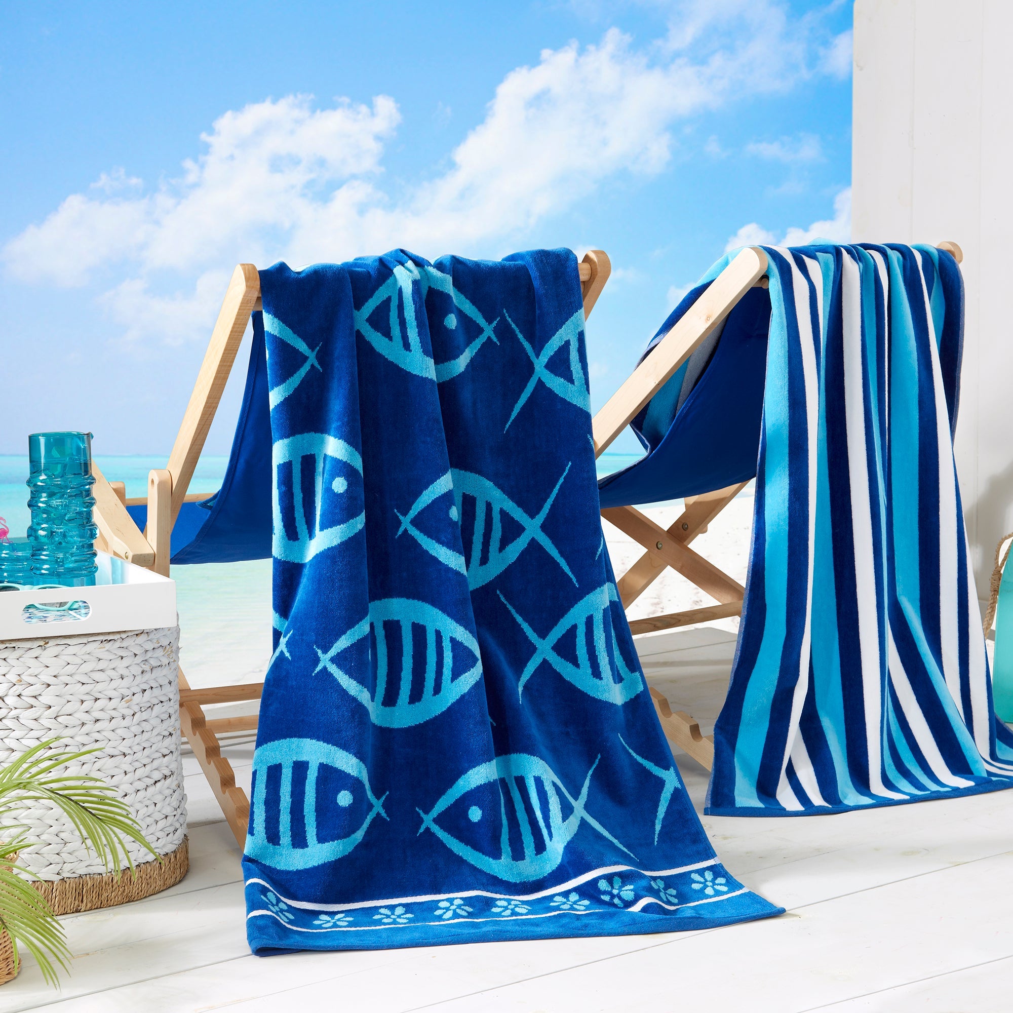 Maui Cotton Velour Beach Towel in vibrant green designs displayed on a chair by the beach.