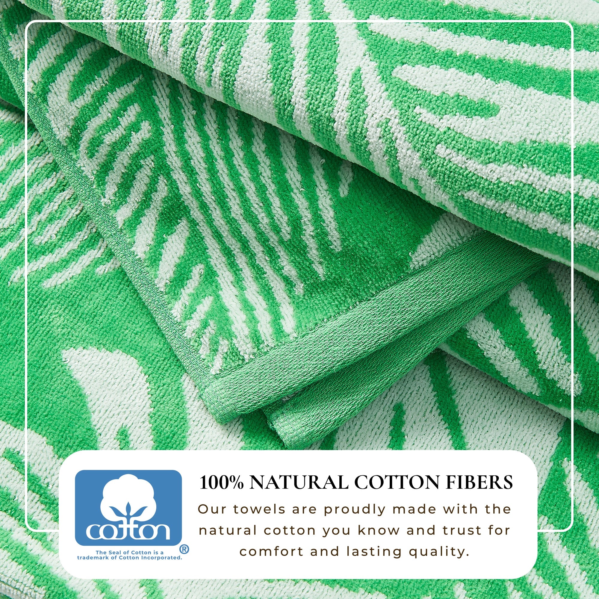 Maui Cotton Velour Beach Towel in vibrant green designs displayed on a chair by the beach.
